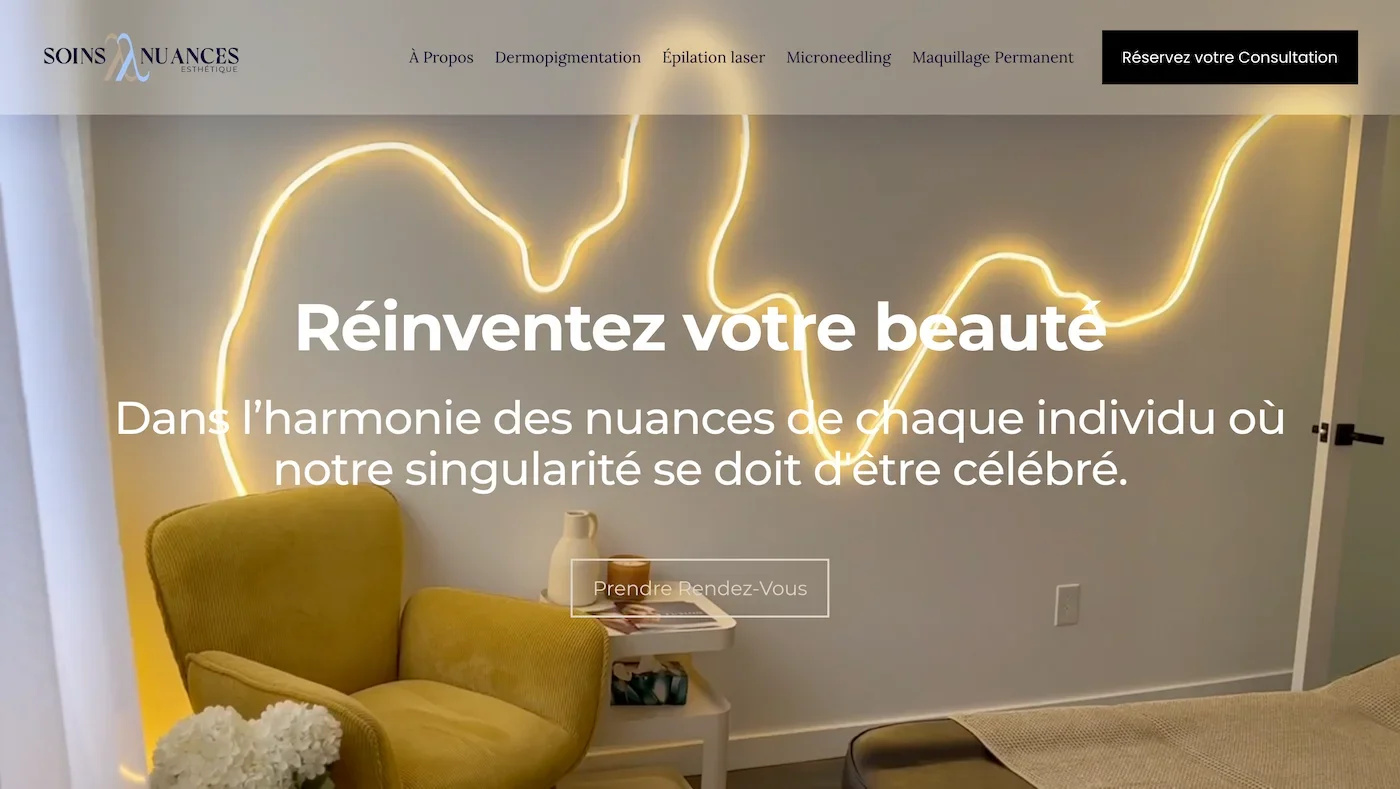 Interior of a beauty clinic with a treatment bed covered with a beige sheet, a small white side table with a ceramic pitcher, candle, and magazines, and a wall with a glowing neon art installation. The website header shows navigation options and a call-to-action button, with bold white text overlaying the image.