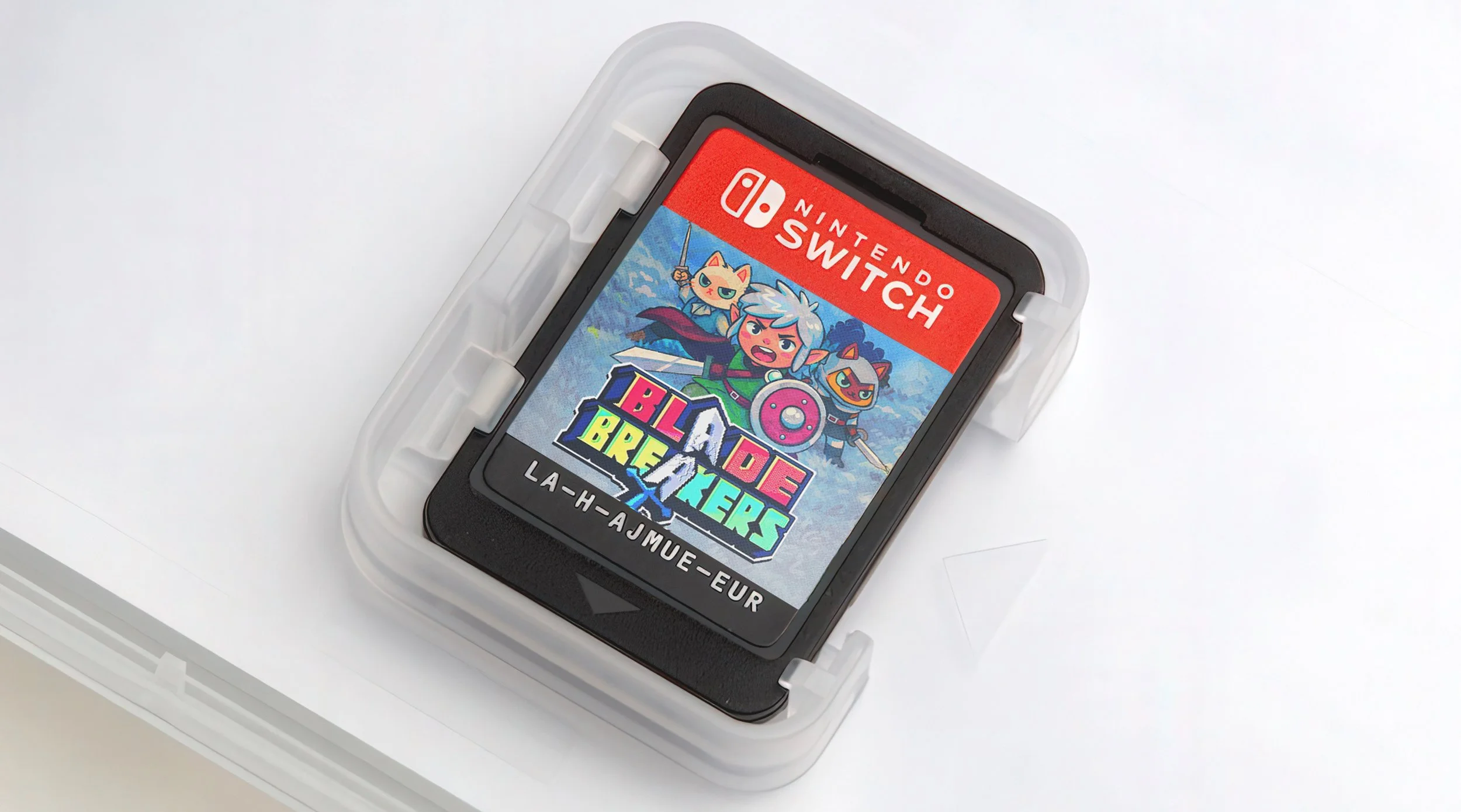 Nintendo Switch game cartridge with colorful label featuring a cartoon adventurer, a cat, and a fox, with the title 'Blades of Brokener' and a background of mountains.