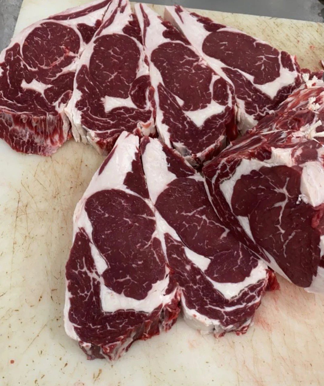 Raw beef short ribs on a cutting board.