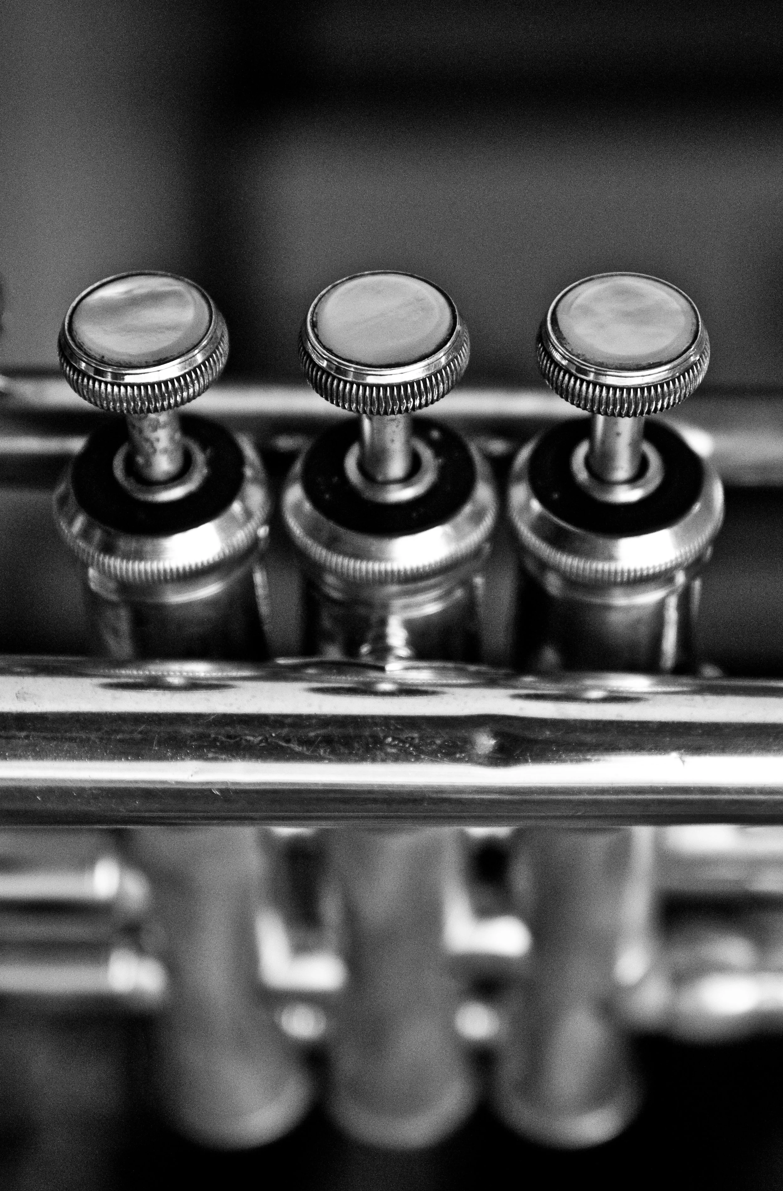 Close-up of trumpet valves and brass details in natural light