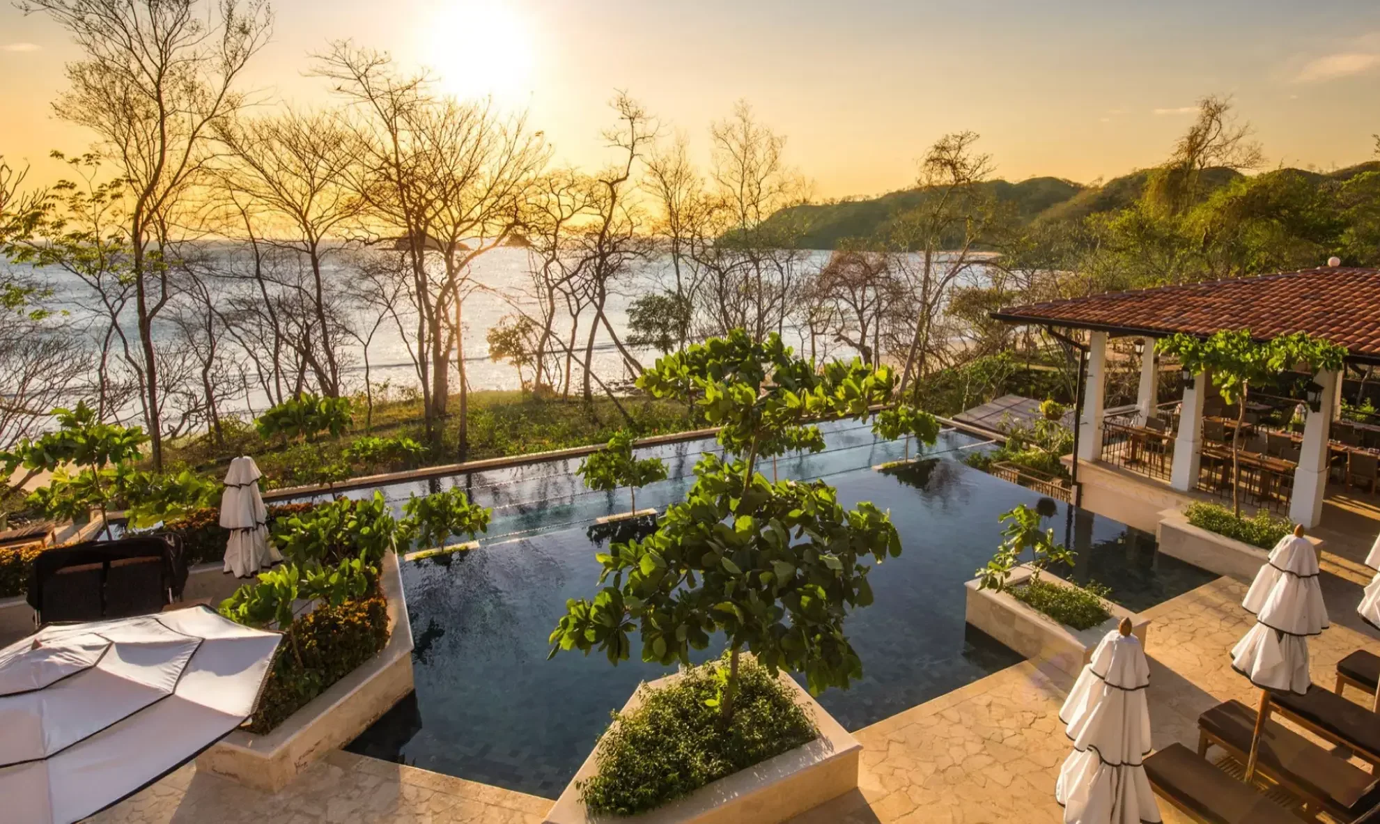 Aerial view of a luxury private beach house with an infinity pool terrace designed by Arosemena and Way and photographed by Brandt, branding and content agency.