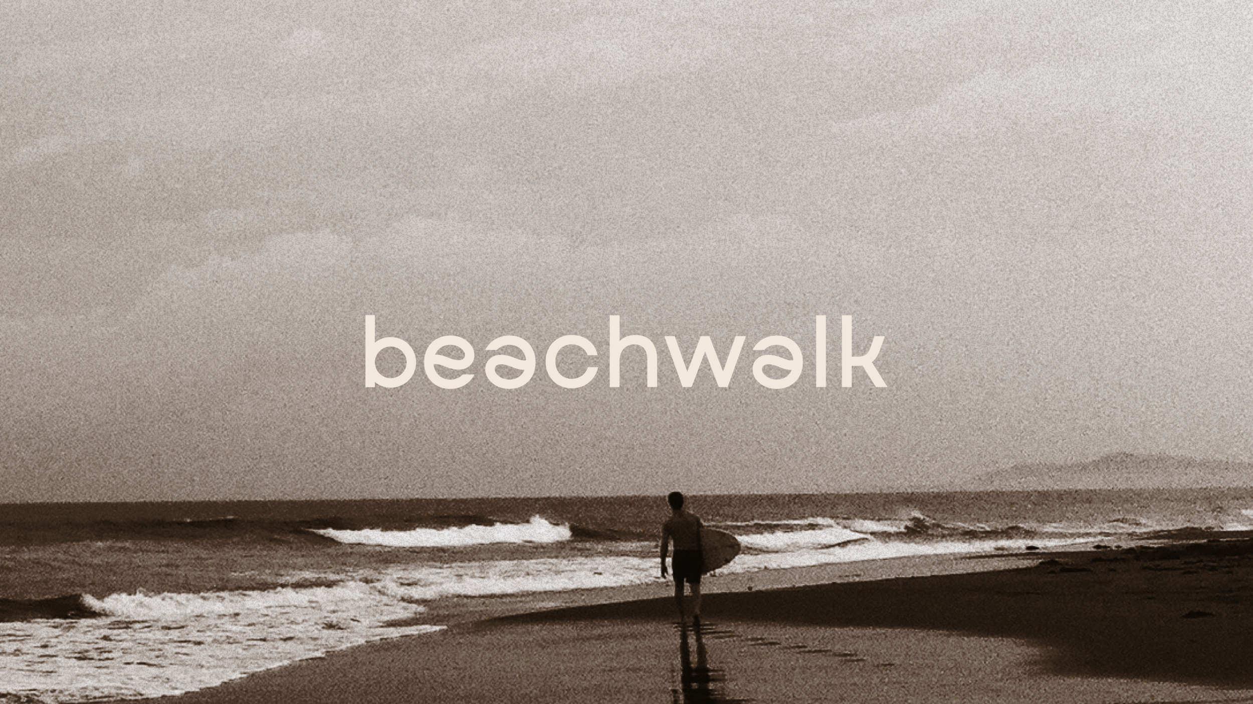 A person walking on a beach with a surfboard under their arm, waves in the ocean, and the word 'beachwalk' printed across the image.
