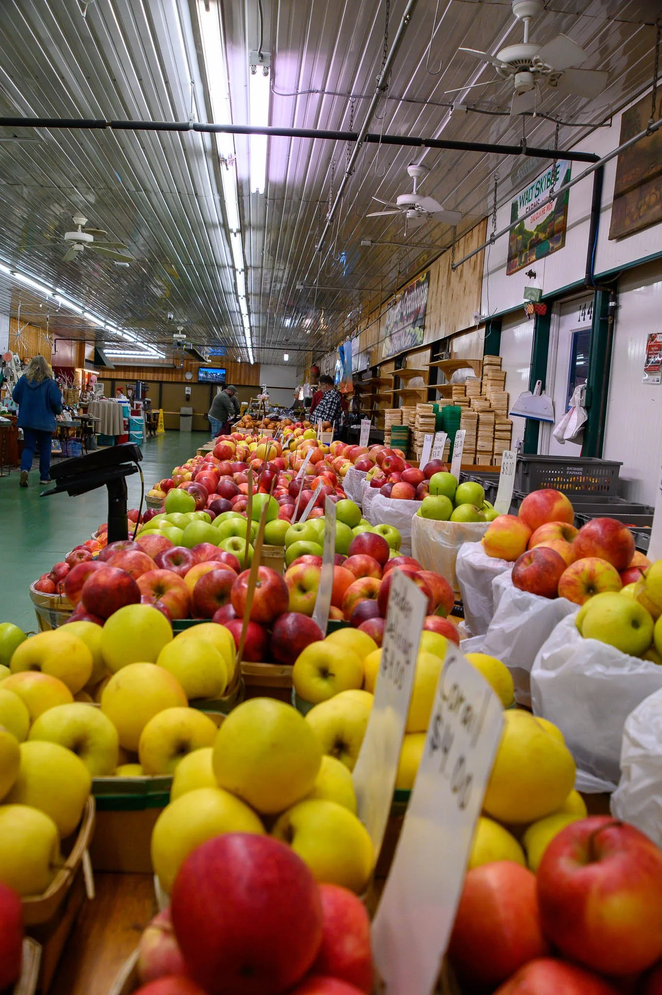 Display of apples and other fruits at a market.