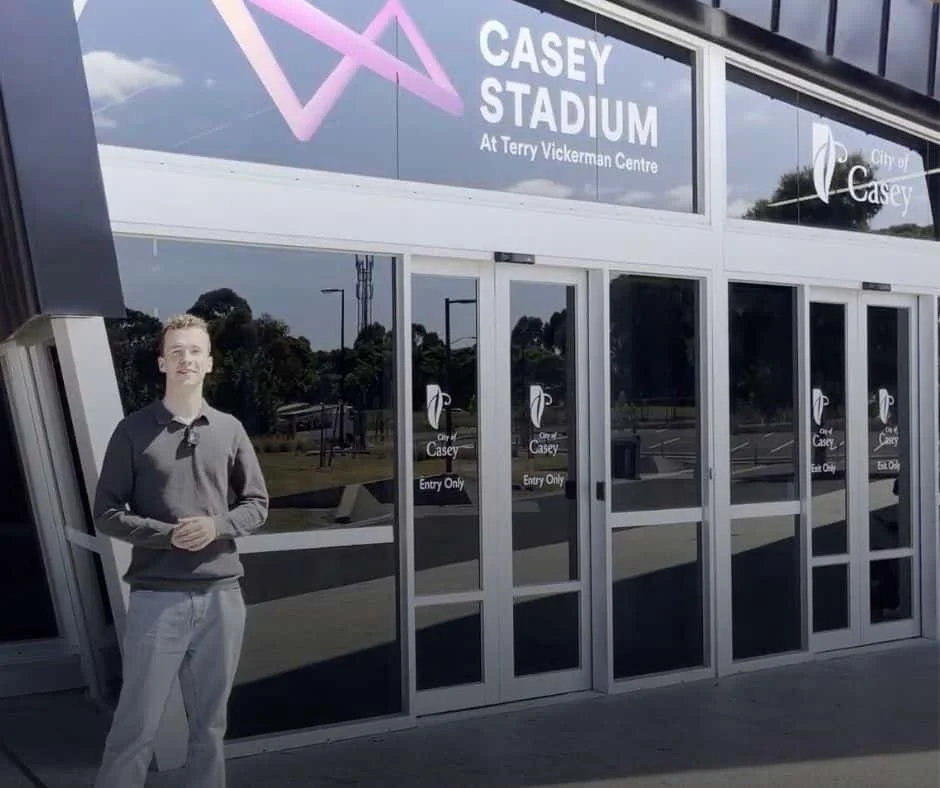 Man standing outside the front door of Race Drive, Cranbourne East at Casey Stadium