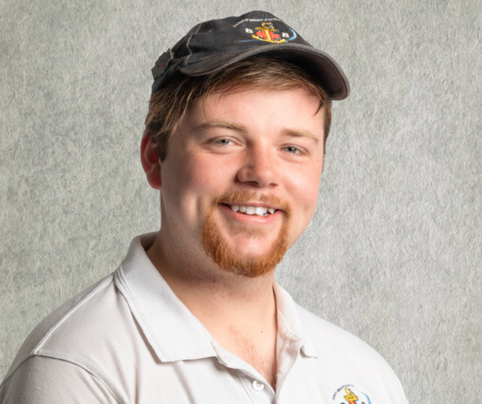 Caleb Noonan is a young man in his twenties who is wearing a boys brigade cap and polo who is the captain of Berwick