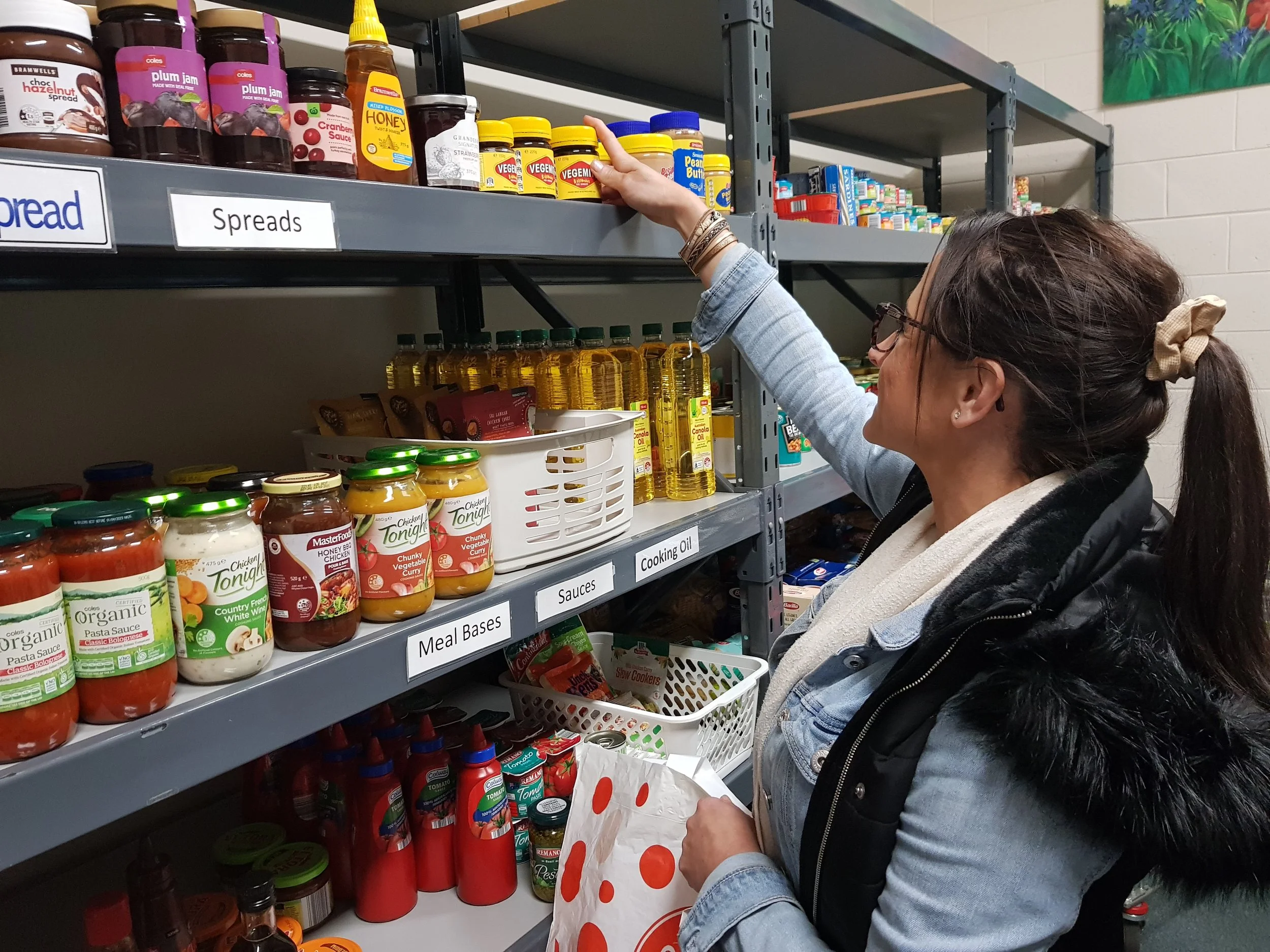 Lady filling shelves with jars