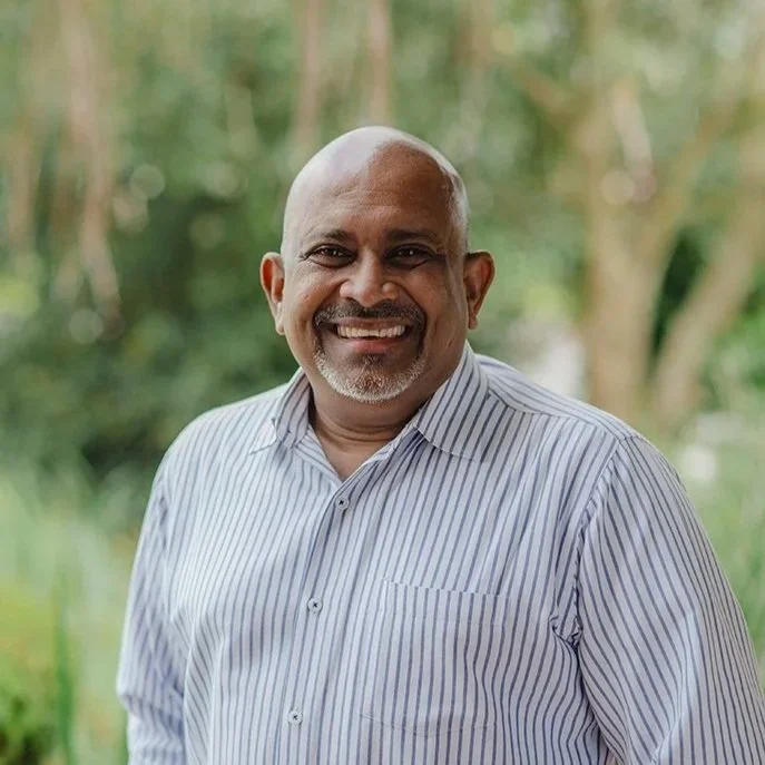 Man in his fifties wearing a blue and white shirt