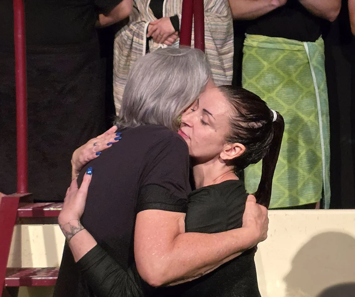 Two ladies hugging