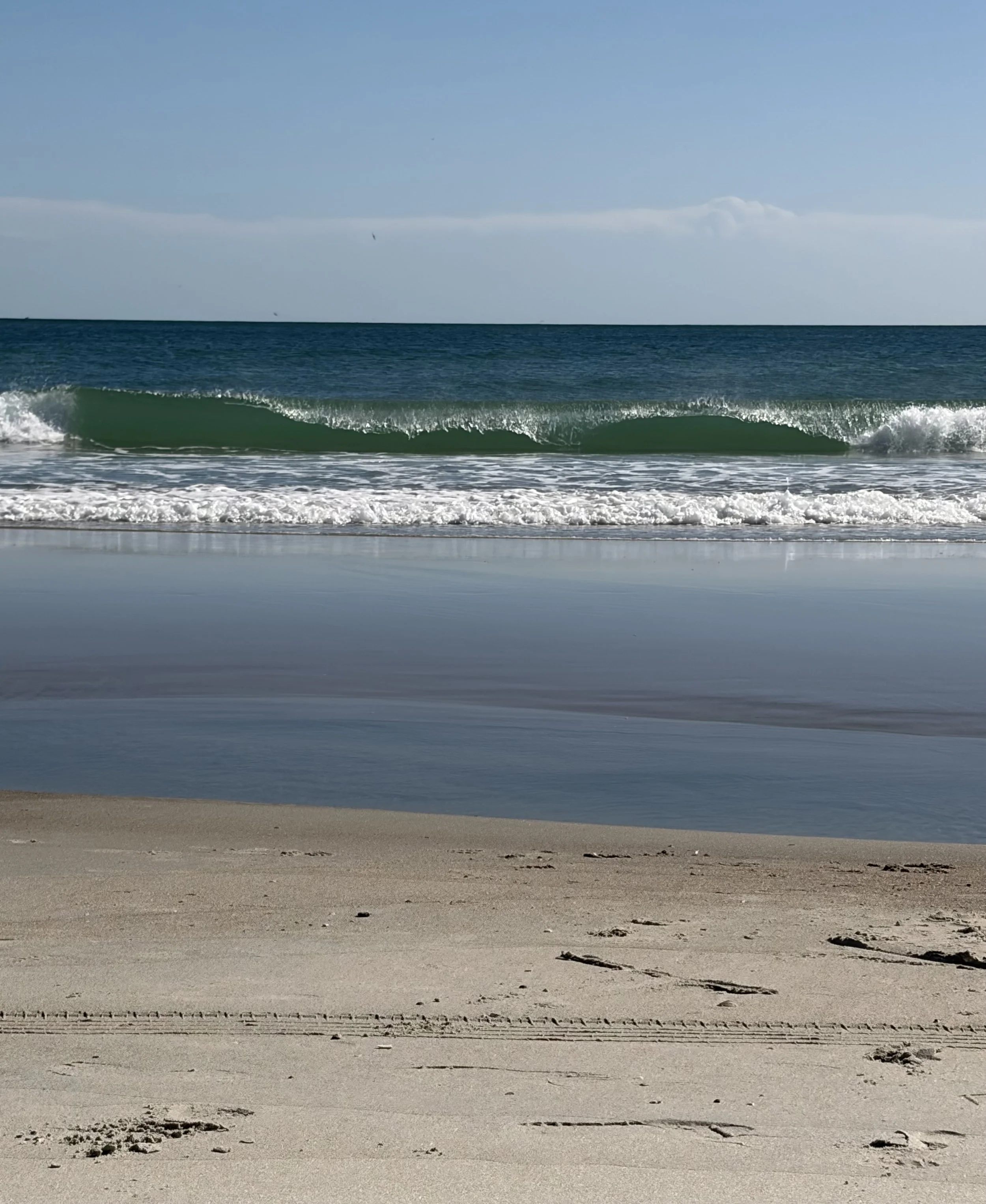 Ocean waves washing onto the shore at low tide on Emerald Isle, NC