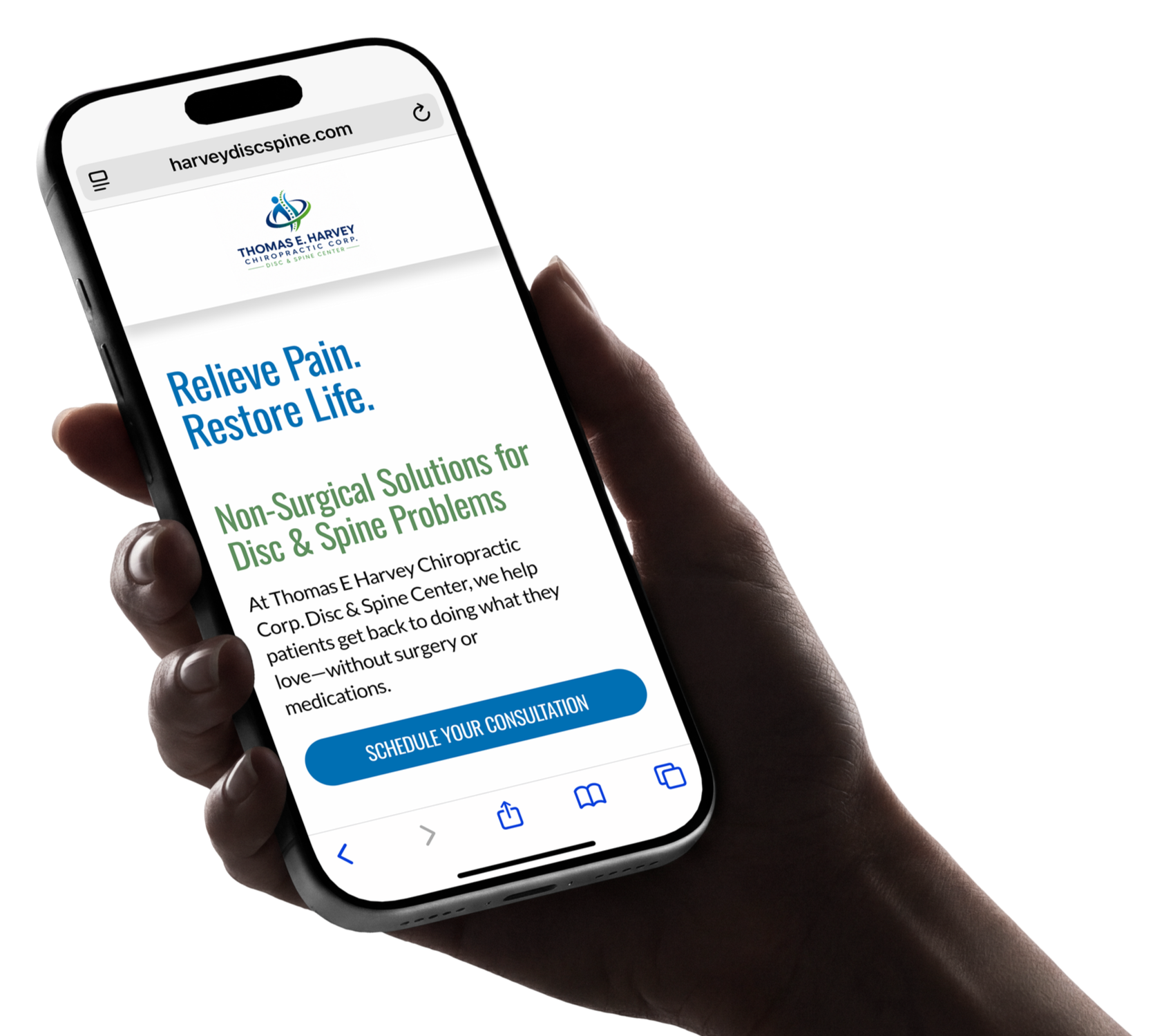 A person holding a smartphone displaying a website for Thomas E. Harvey Chiropractic, showing a message to relieve pain and restore life with non-surgical solutions for disc and spine problems, and a button to schedule a consultation.