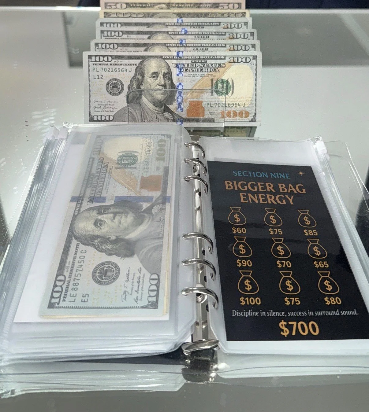 A display of U.S. 100-dollar bills and a menu showing energy drink prices ranging from 60 to 100 dollars, with the total amount of 700 dollars on the menu.