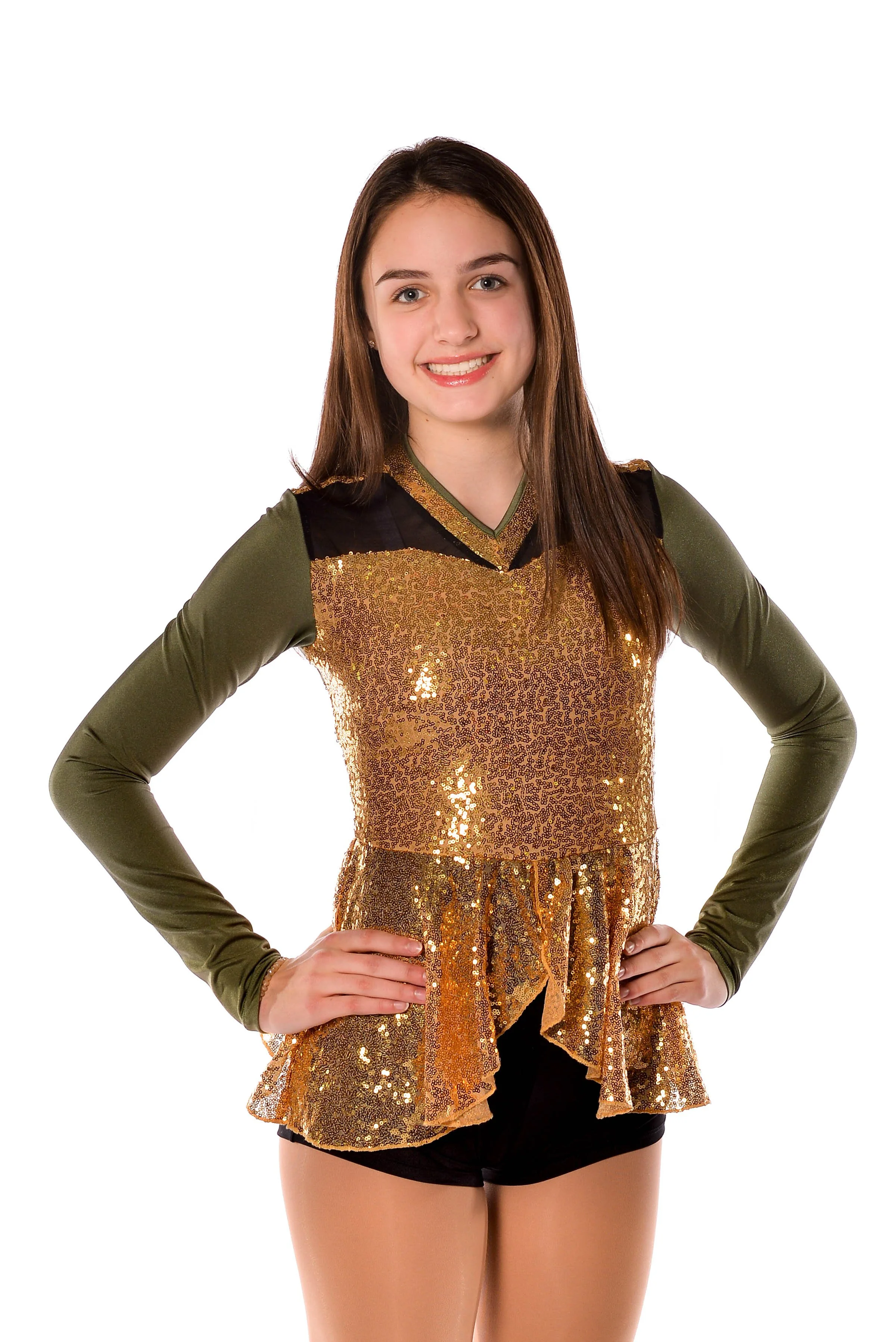 Young woman in a sparkly gold dance costume with olive green long sleeves, posing with hands on hips and smiling against a white background.