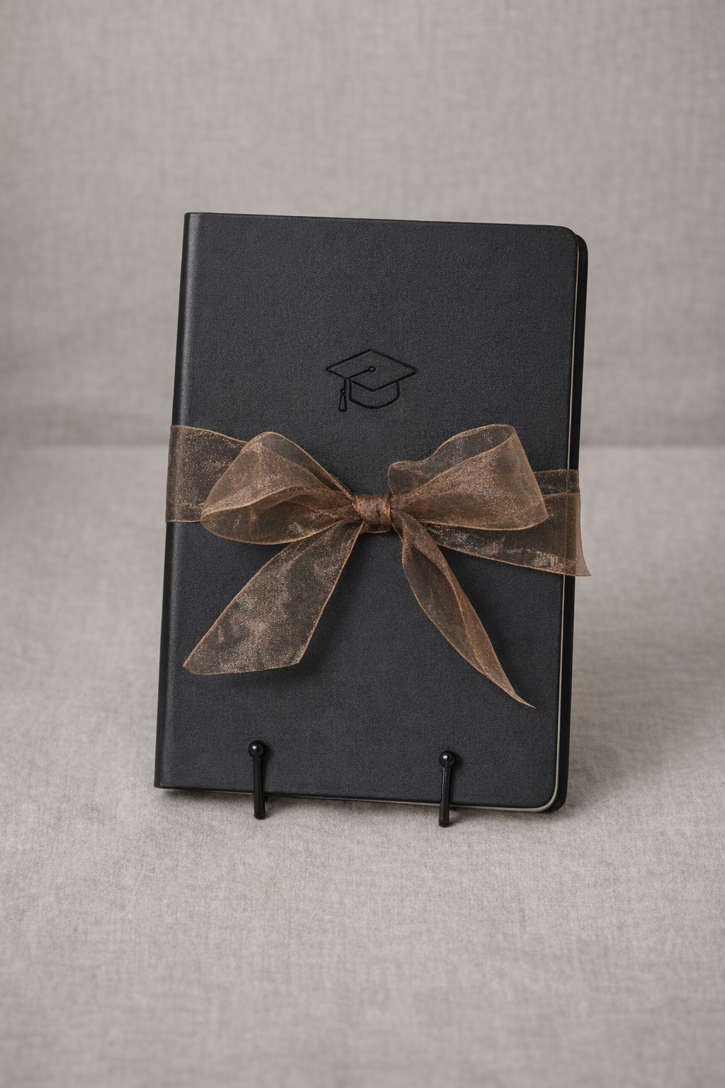 Graduation journal with elegant ribbon bow.png
