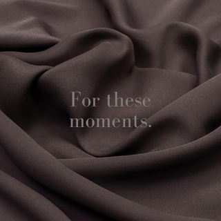 Close-up of two pairs of hands gently touching, conveying comfort and support.