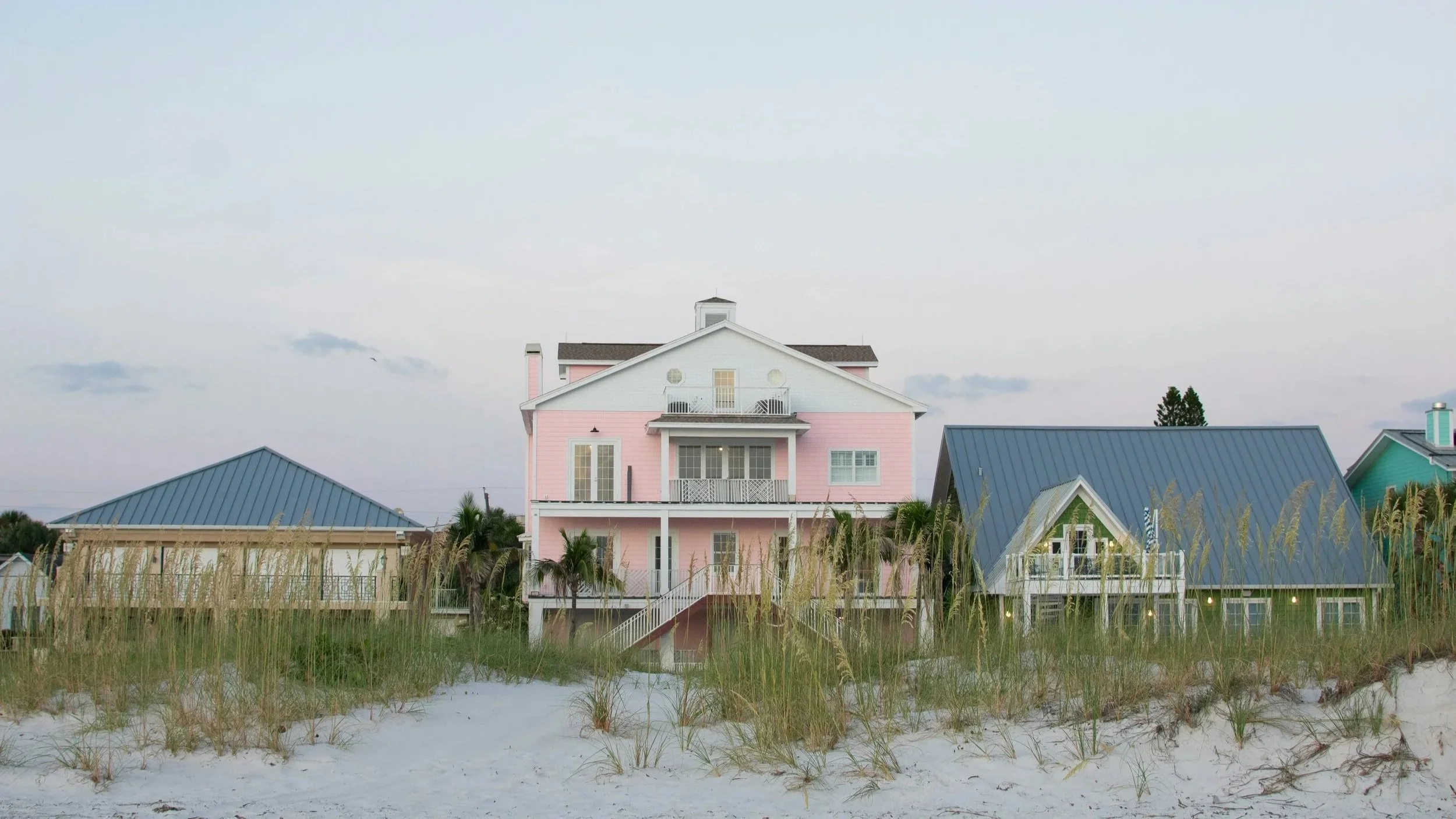 A row of colorful houses on the beach.