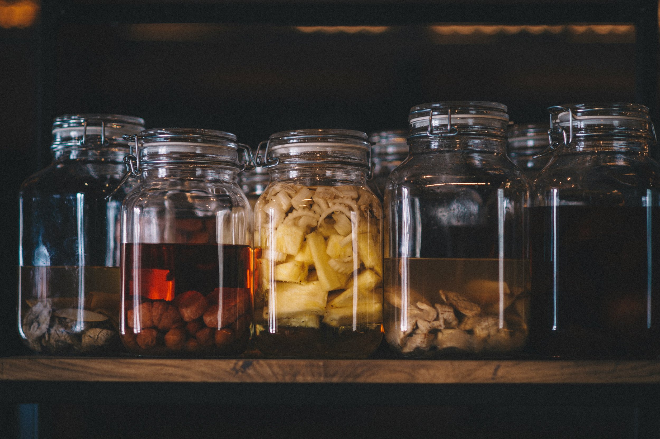 Jars of canned food on a shelf.