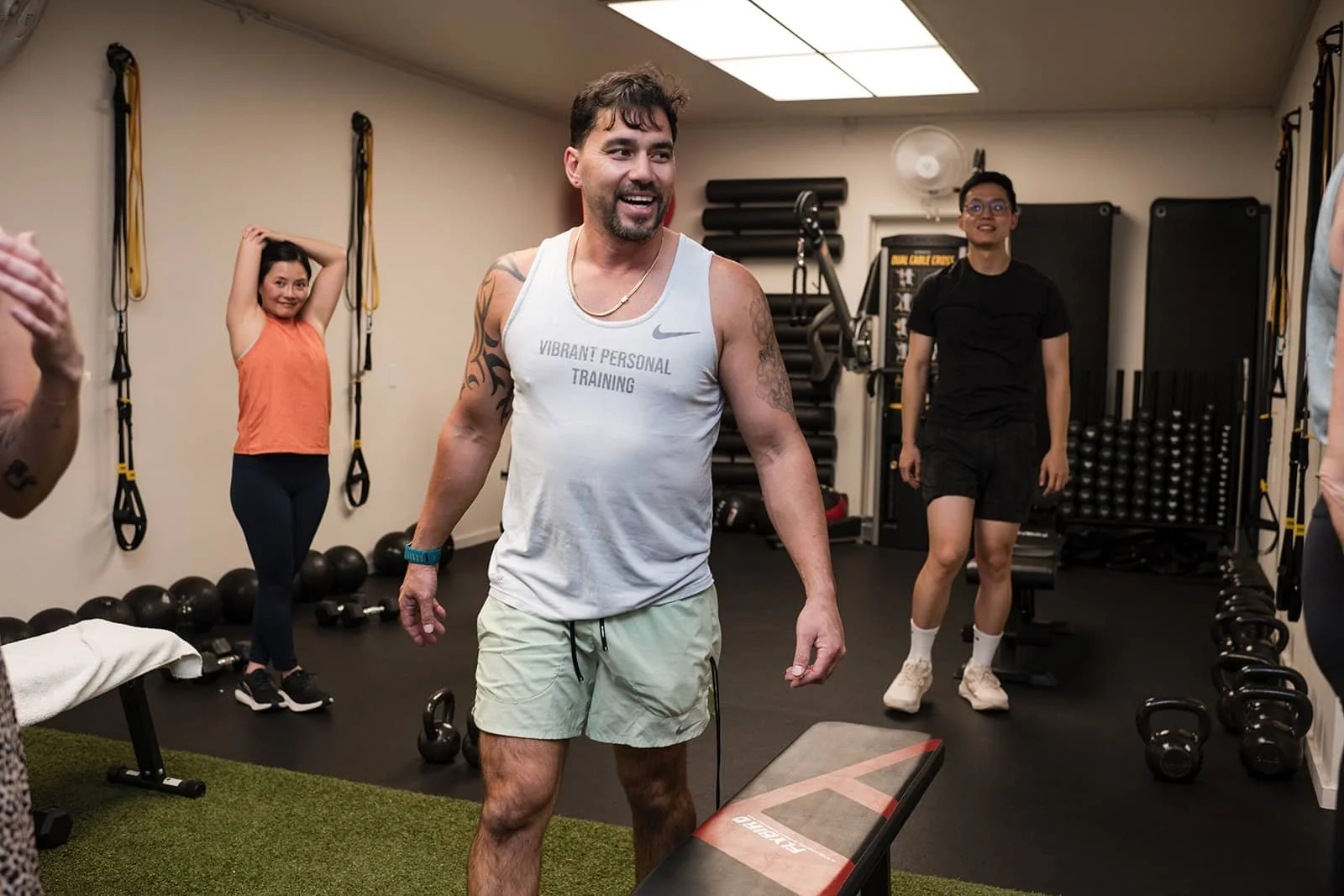 Personal trainer leading session in gym