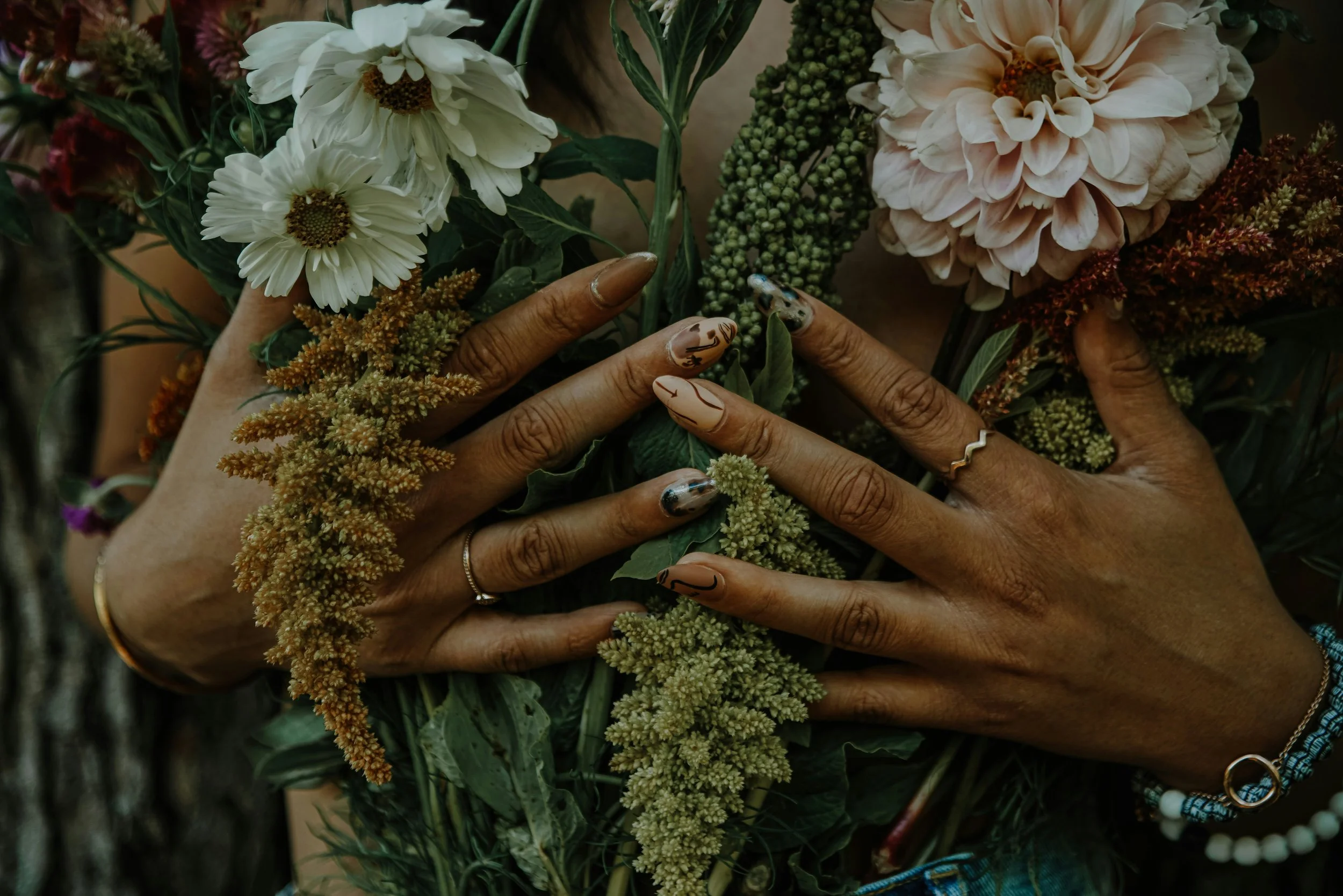 Hands holding flowers representing plant medicine healing, integration, and intuitive spiritual care in Chicago
