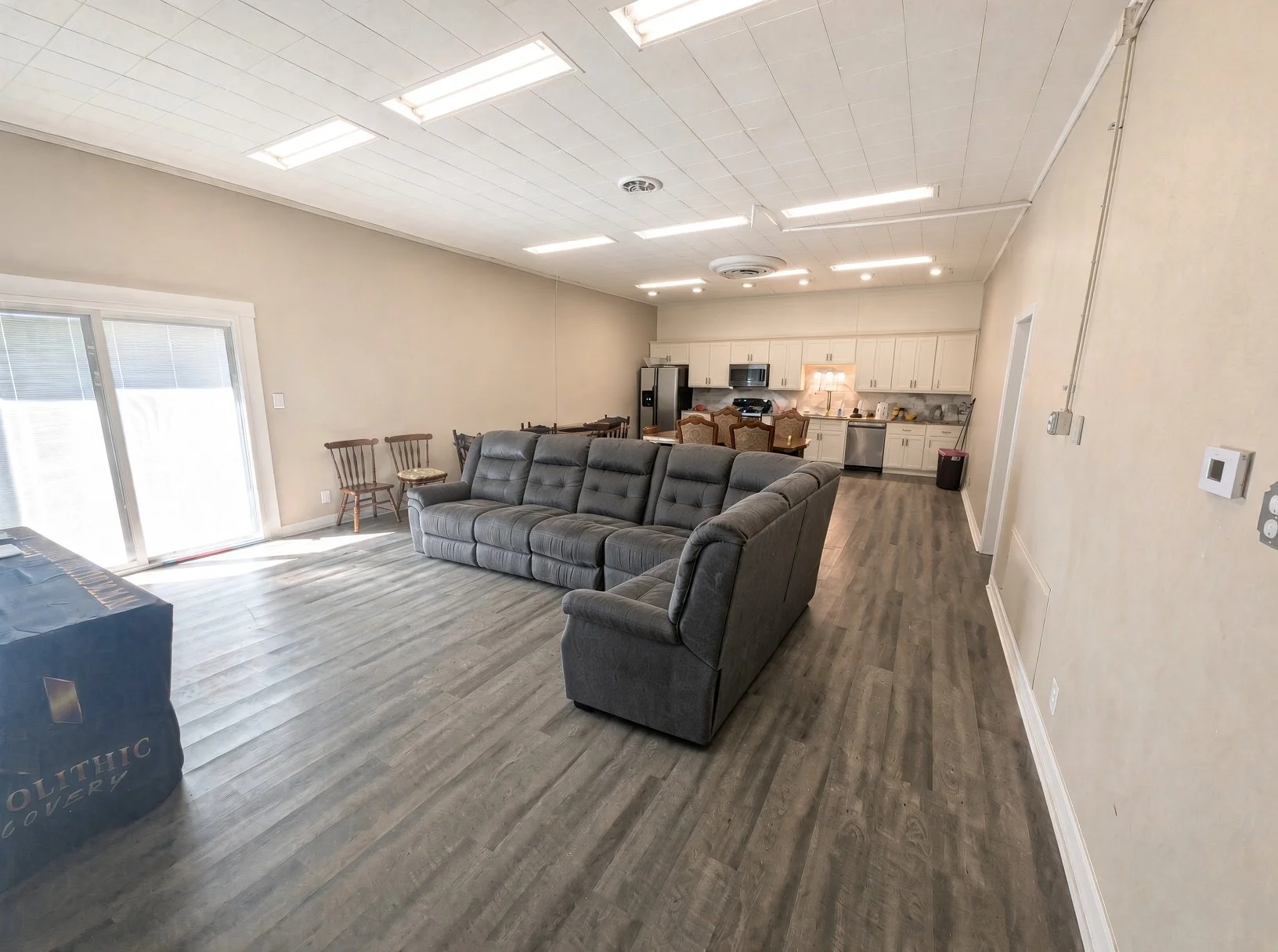 Open living room with sectional sofa at Wolf on Main sober living home