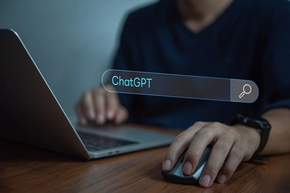 Employee using ChatGPT on a laptop for business tasks raising chatgpt business data privacy concerns about sensitive information sharing
