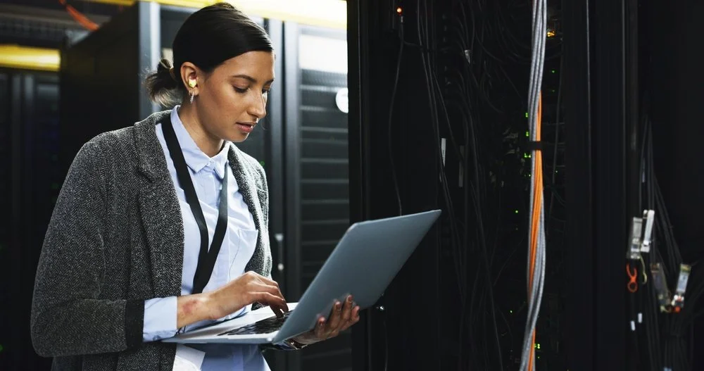 Small business owner asking do i need a server for my business while reviewing IT infrastructure options with a Gennix consultant in a Lower Mainland office
