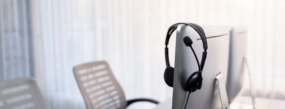 Business professional using VoIP for business Canada setup on a laptop and headset in a Lower Mainland office managed by Gennix