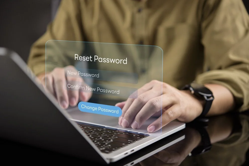 Small business owner setting up a free password manager for small business on a laptop with help from a Gennix IT consultant in a Lower Mainland office
