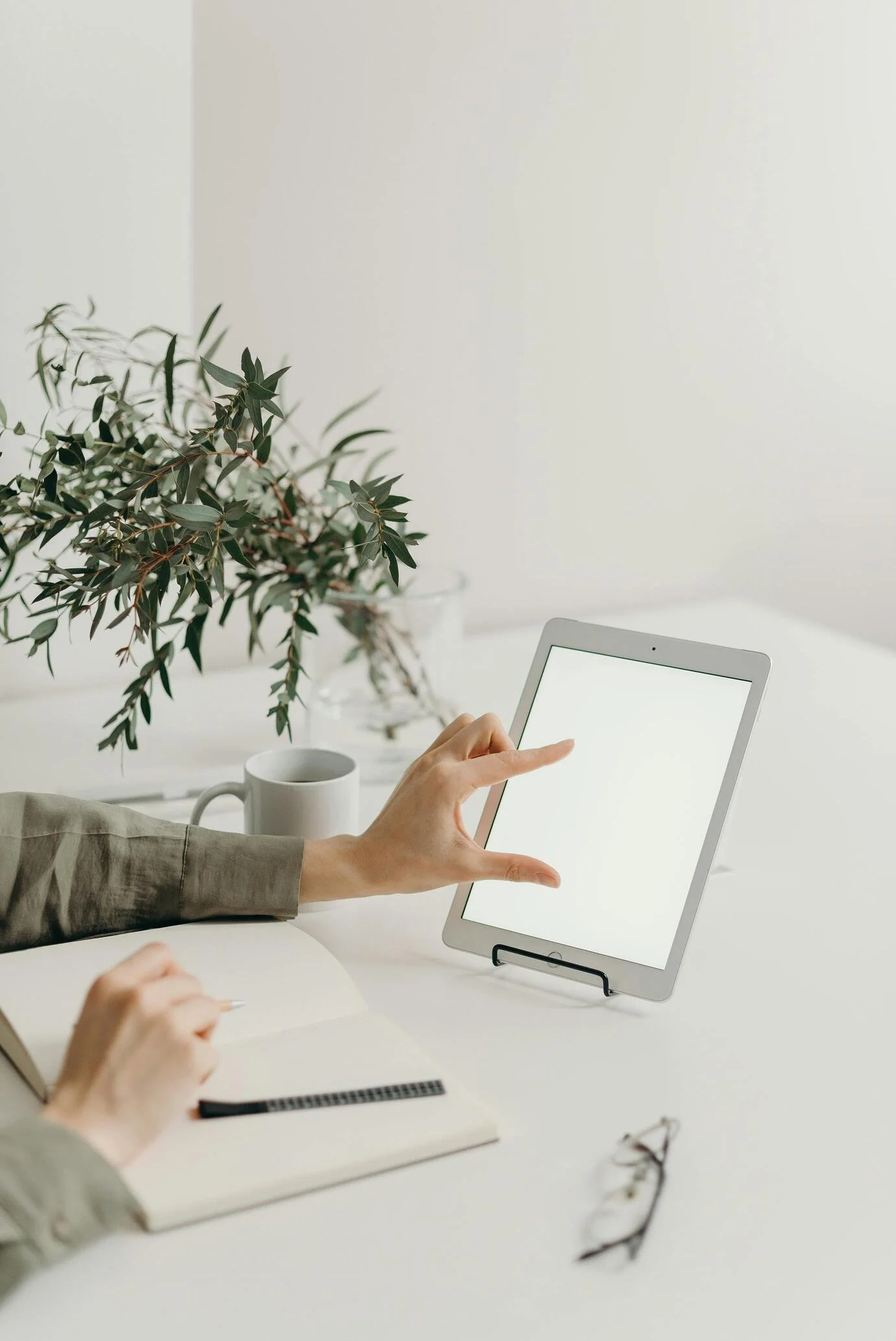 Business professional taking notes at a desk while planning cybersecurity improvements and penetration testing services in Vancouver