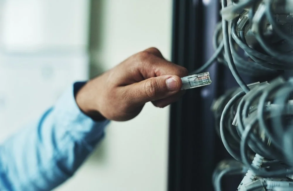 Surrey BC office team working on reliable systems maintained through IT support Surrey from Gennix
