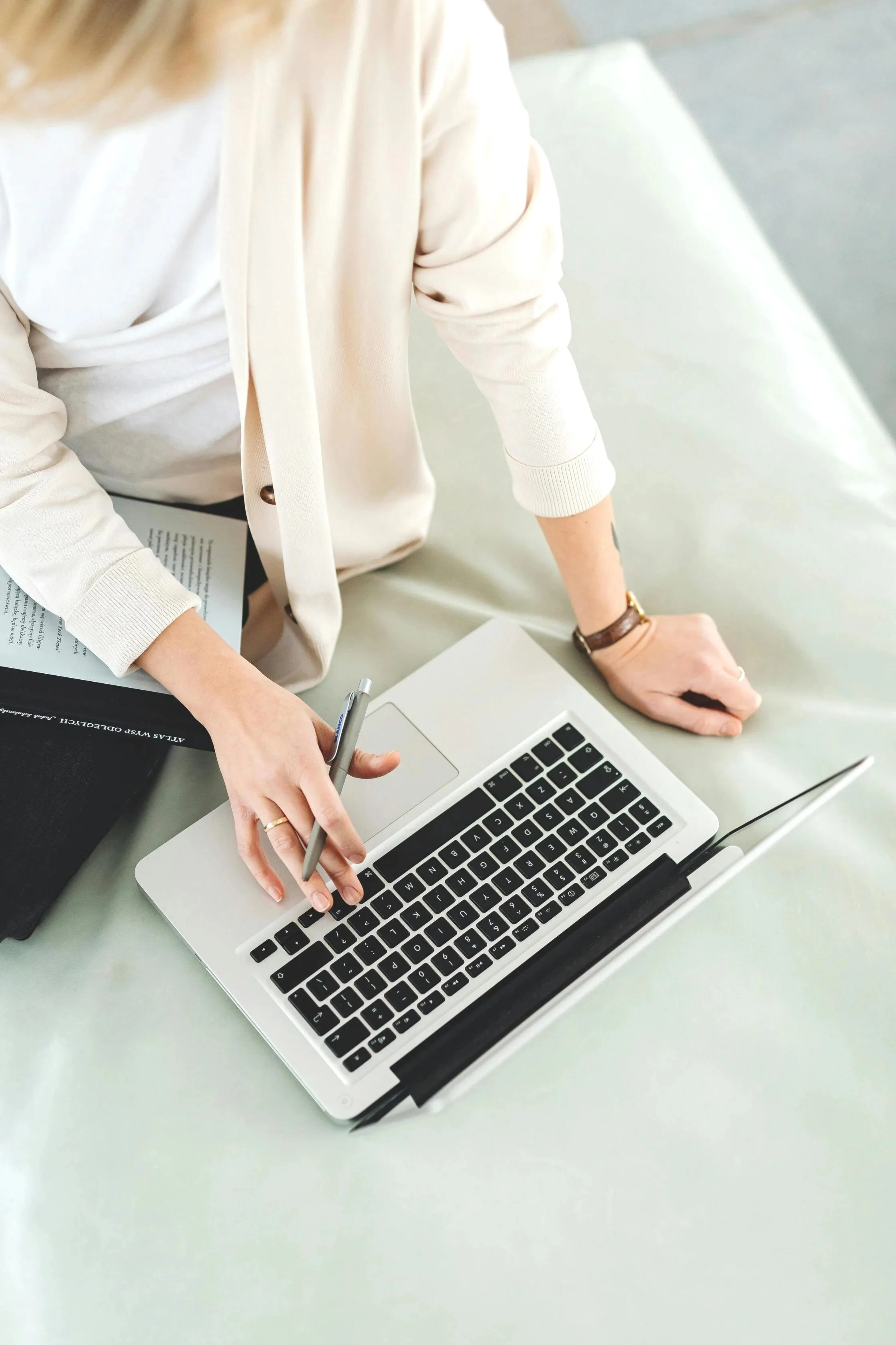 Healthcare administrator working on a laptop and documents, representing managed IT services for healthcare clinics