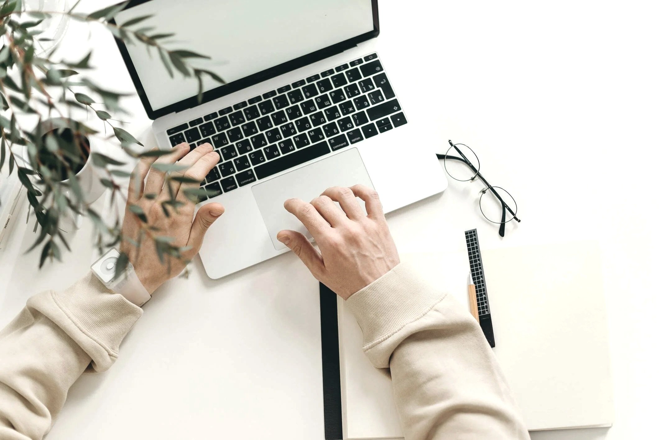 Top-down view of a laptop on a white desk of a Gennix employee, a Managed IT Services Vancouver provider, that supports day-to-day IT operations for businesses.