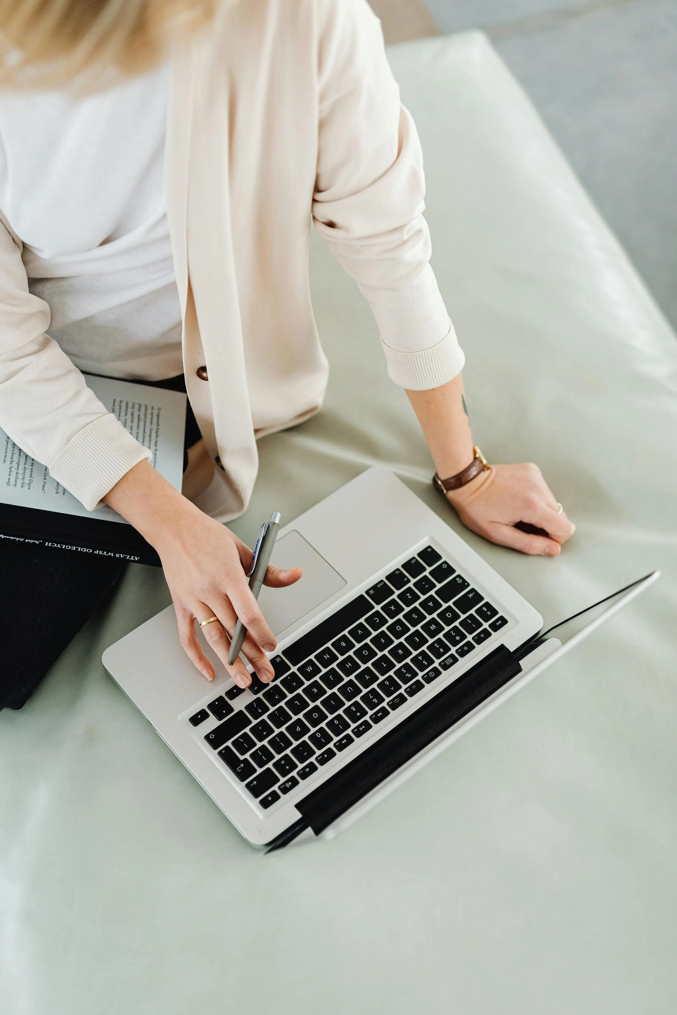 A professional standing at a desk using a laptop and reviewing documents, typical of workplaces relying on managed IT services in Canada, British Columbia (BC) in the Vancouver region