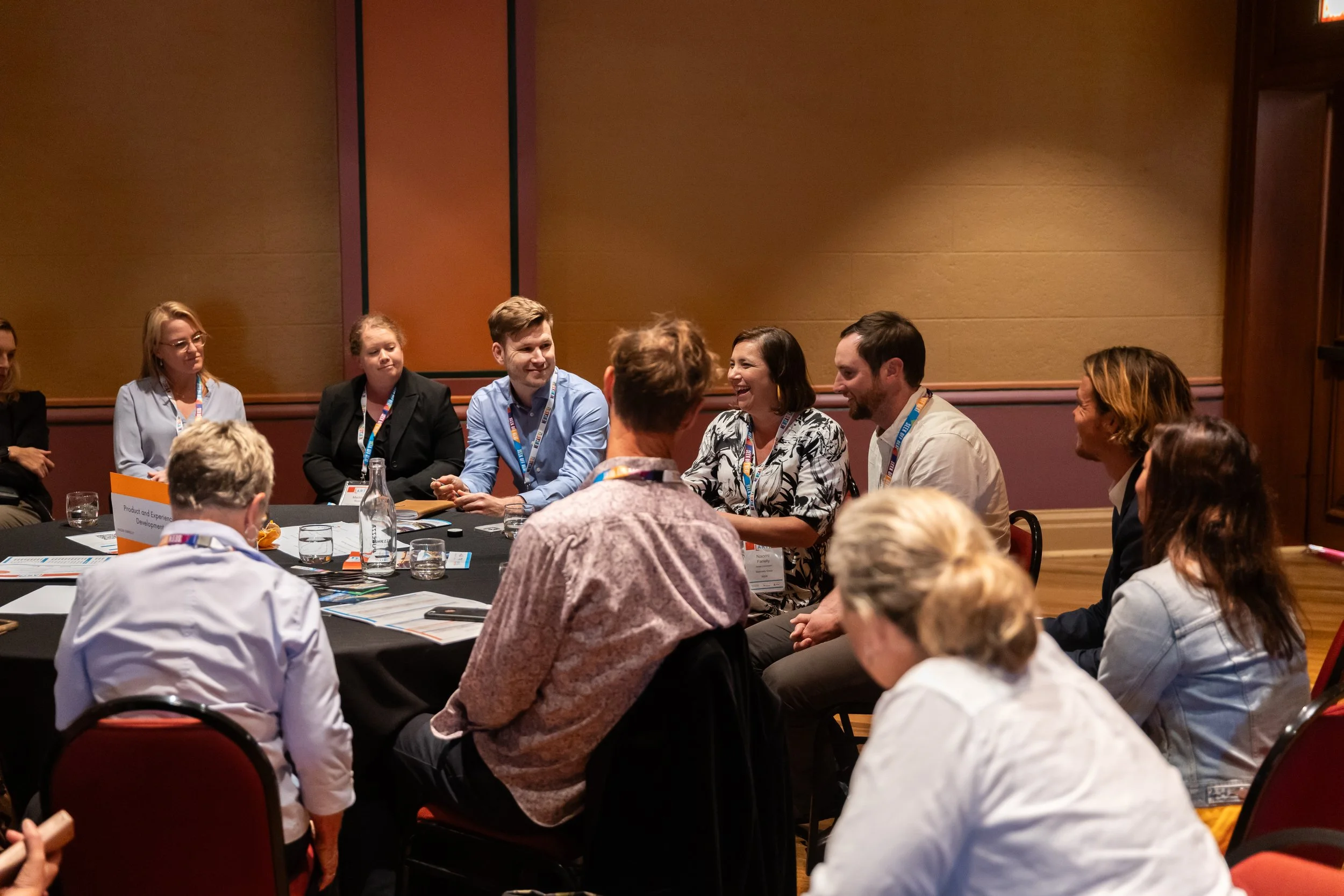 Workshop participants sit in a circle sharing insights and perspectives, demonstrating active discussion and peer learning.