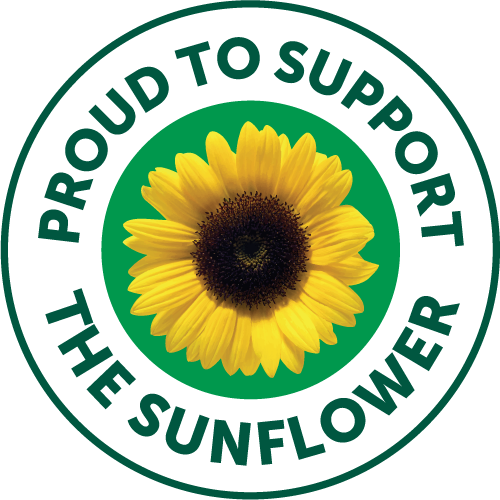 Circular badge featuring a sunflower with the words “Proud to Support the Sunflower,” aligned with the Hidden Disabilities Sunflower initiative promoting awareness and inclusion for people with non-visible disabilities.