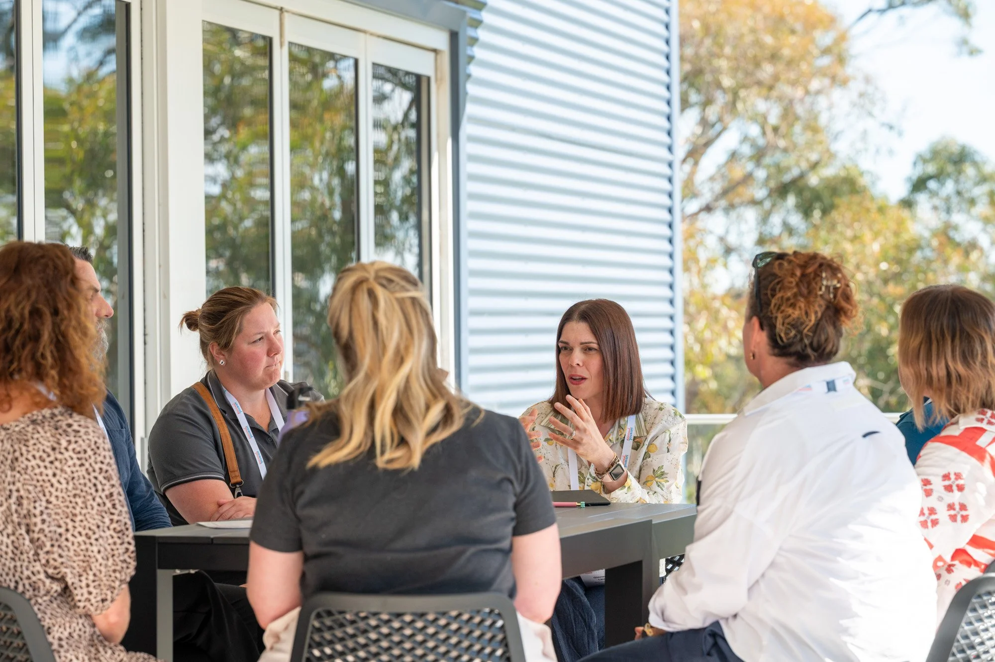 Giovanna Lever facilitates a small group discussion, engaging participants in conversation and collaborative problem-solving.