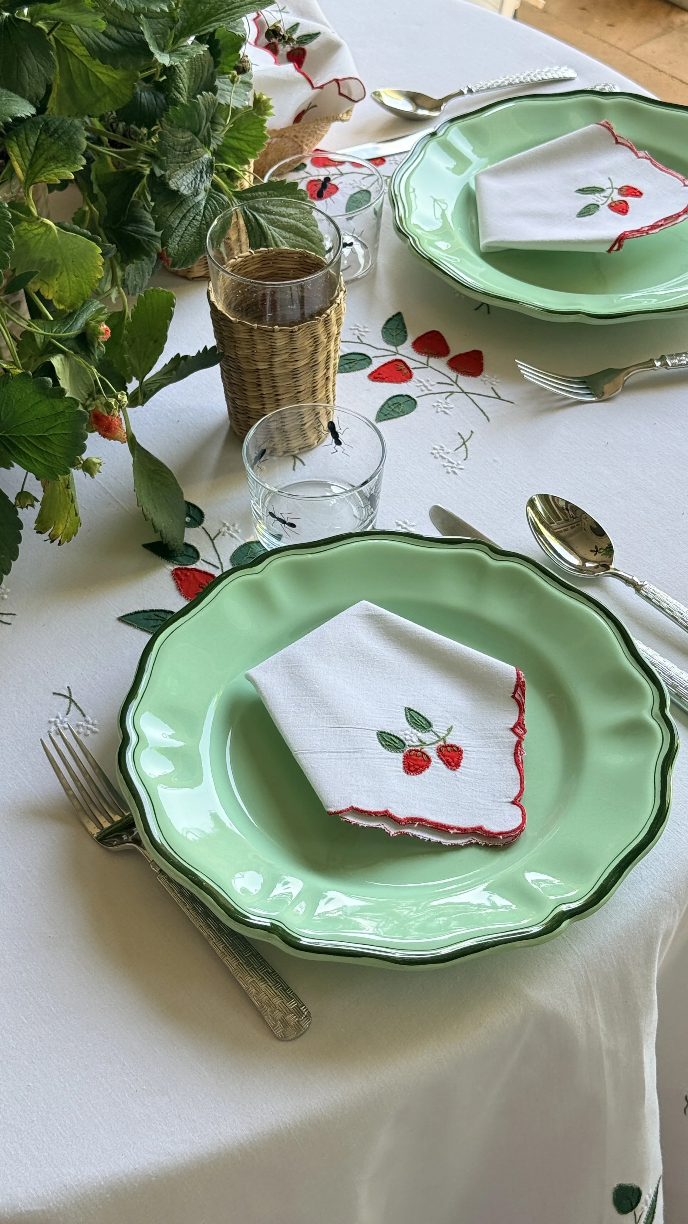 Green plate with strawberry embroidered napkins