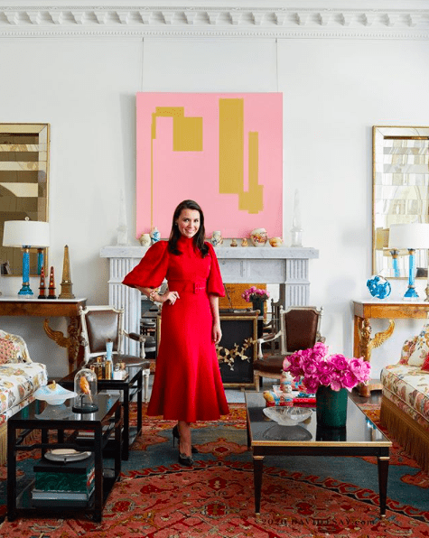 Kimberly Whitman in living room with white walls, pink painting and Nemadji Pottery