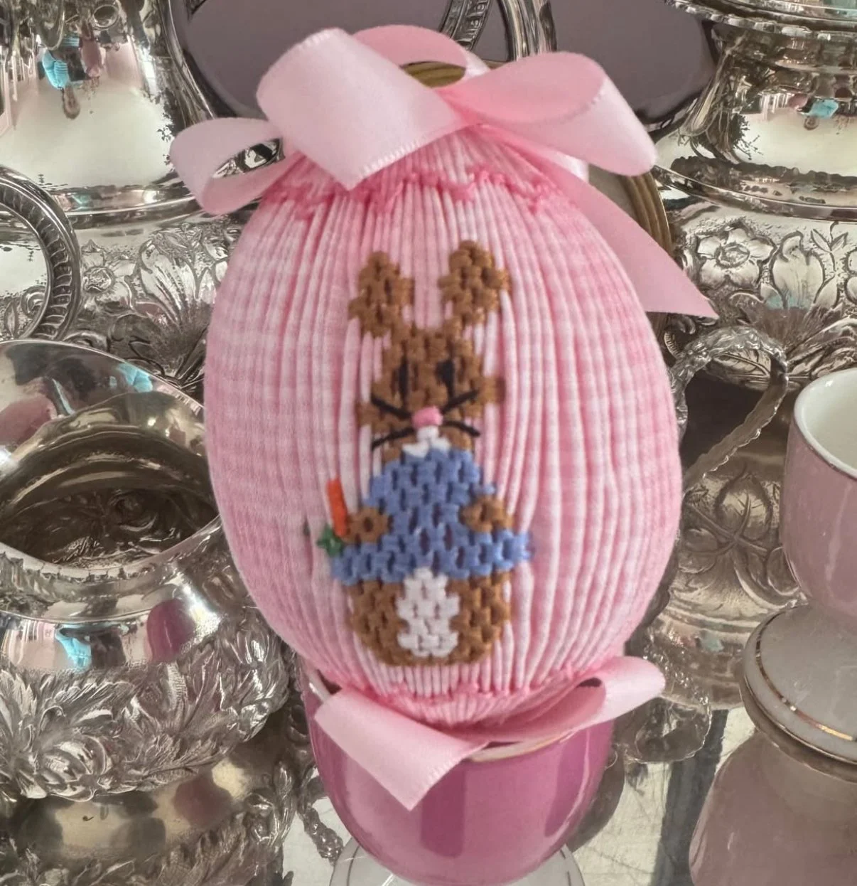 Charming pink smocked egg with peter cottontail surrounded by silver
