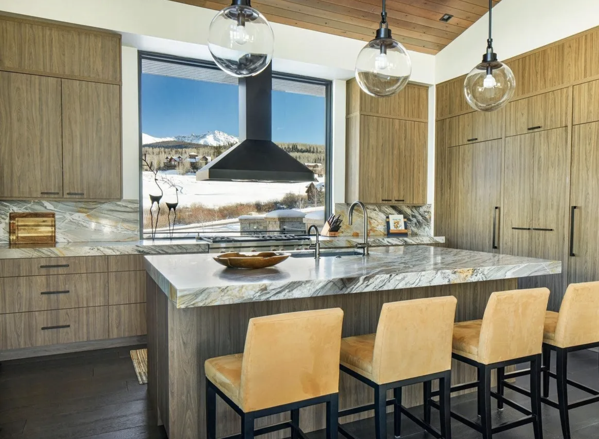 Kitchen with chipped glass backsplash and walnut cabinets