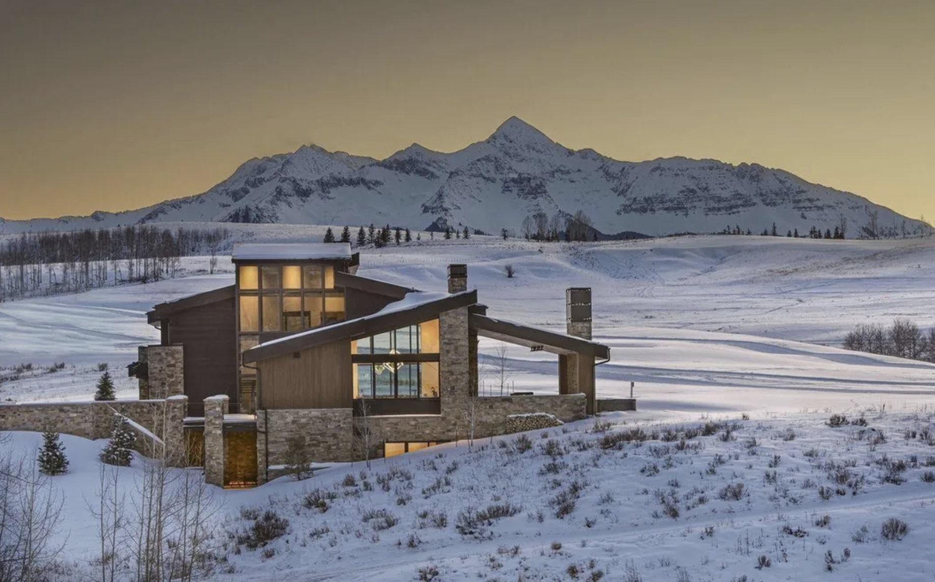 Exterior of a contemporary home and Wilson peak mountains in the background