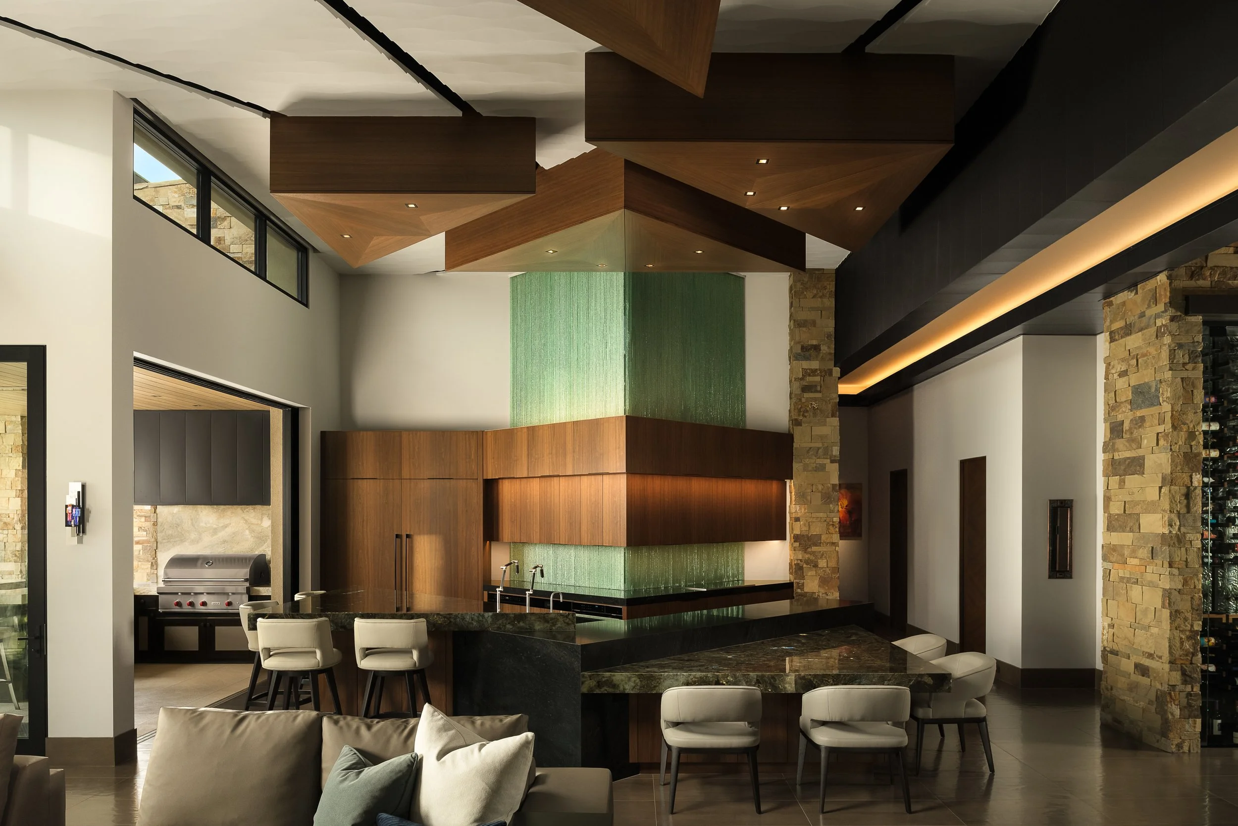 Kitchen with chipped glass backsplash and walnut cabinets