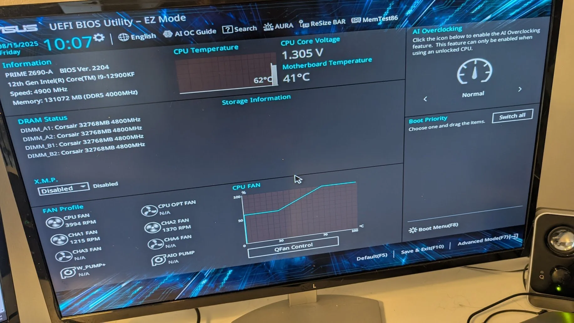 Computer monitor displaying ASUS UEFI BIOS Utility in EZ Mode, showing system information, CPU temperature, core voltage, RAM status, and fan profiles.