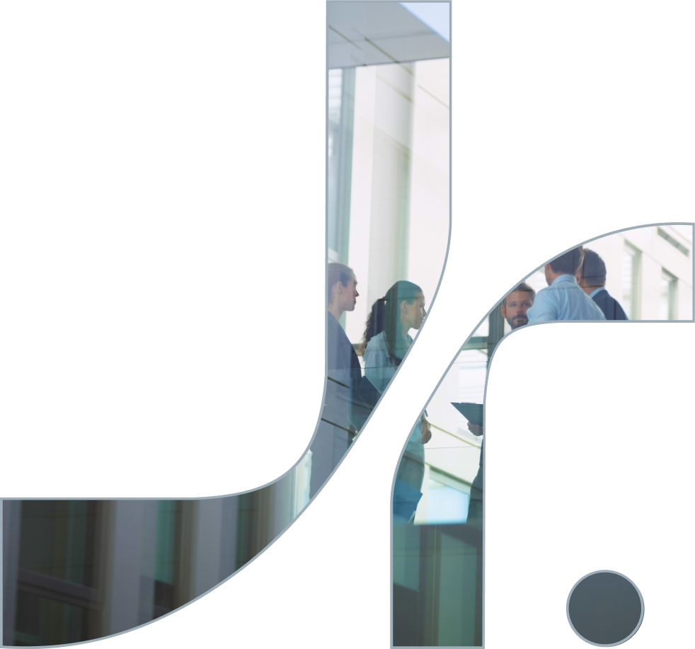 Business people having a discussion in a modern conference area with large windows.