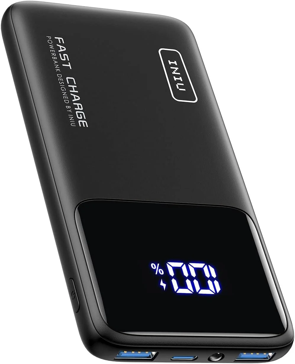 A portable black power bank with a digital display showing 0% charge, a USB port, and charging indicators.