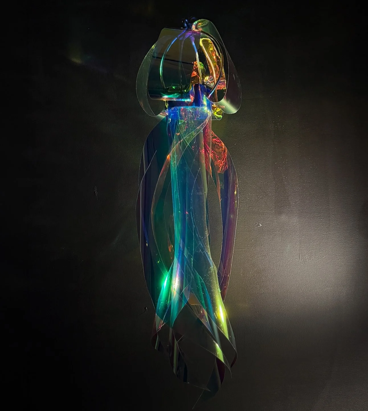 Video: "Spiral of Swimming Light" | 2026 | Iridescent foil, steel wire, monofilament, metal hook, canvas, 36 x 48 x 12 in.