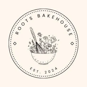 A circular logo with a bowl of flowers and feathers, featuring the text 'Roots Bakehouse' and 'Est. 2024'.