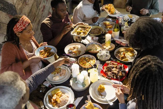 focused_209607870-stock-photo-family-enjoying-caribbean-christmas-dinner.jpg