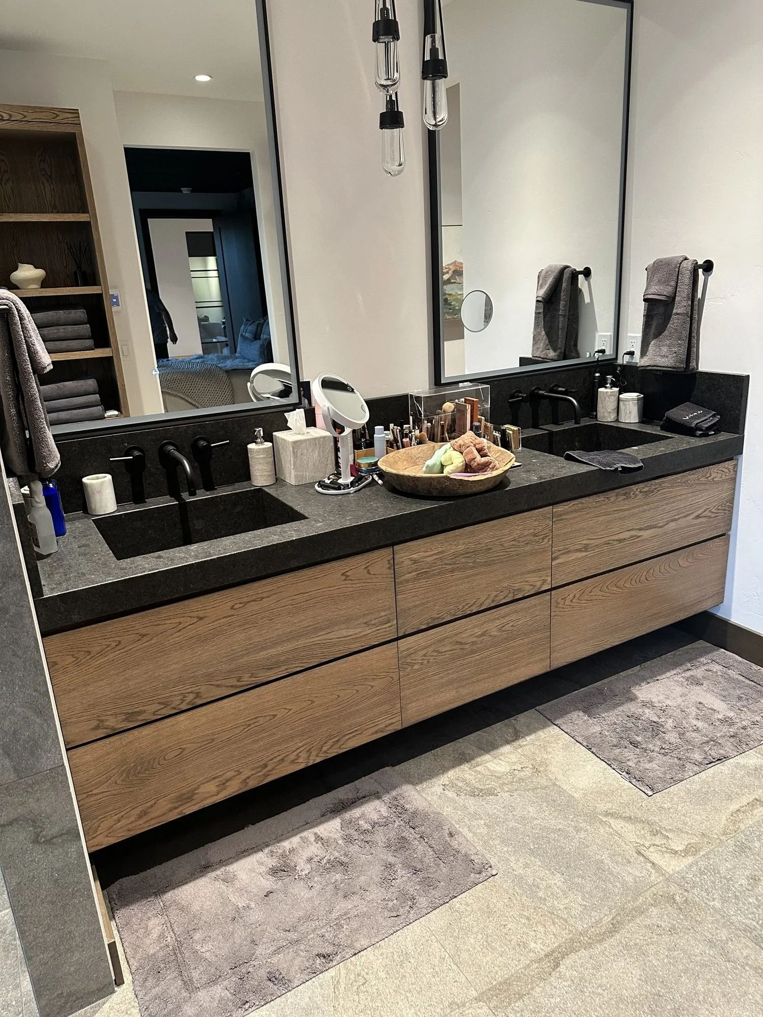 Angled view of the wire-brushed white oak floating vanity and its drawer fronts