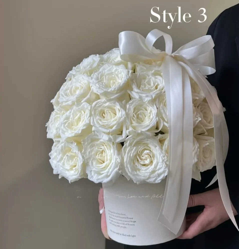 A person holds a round white box filled with white roses and decorated with a white satin ribbon bow. The box is labeled 'Style 3'.