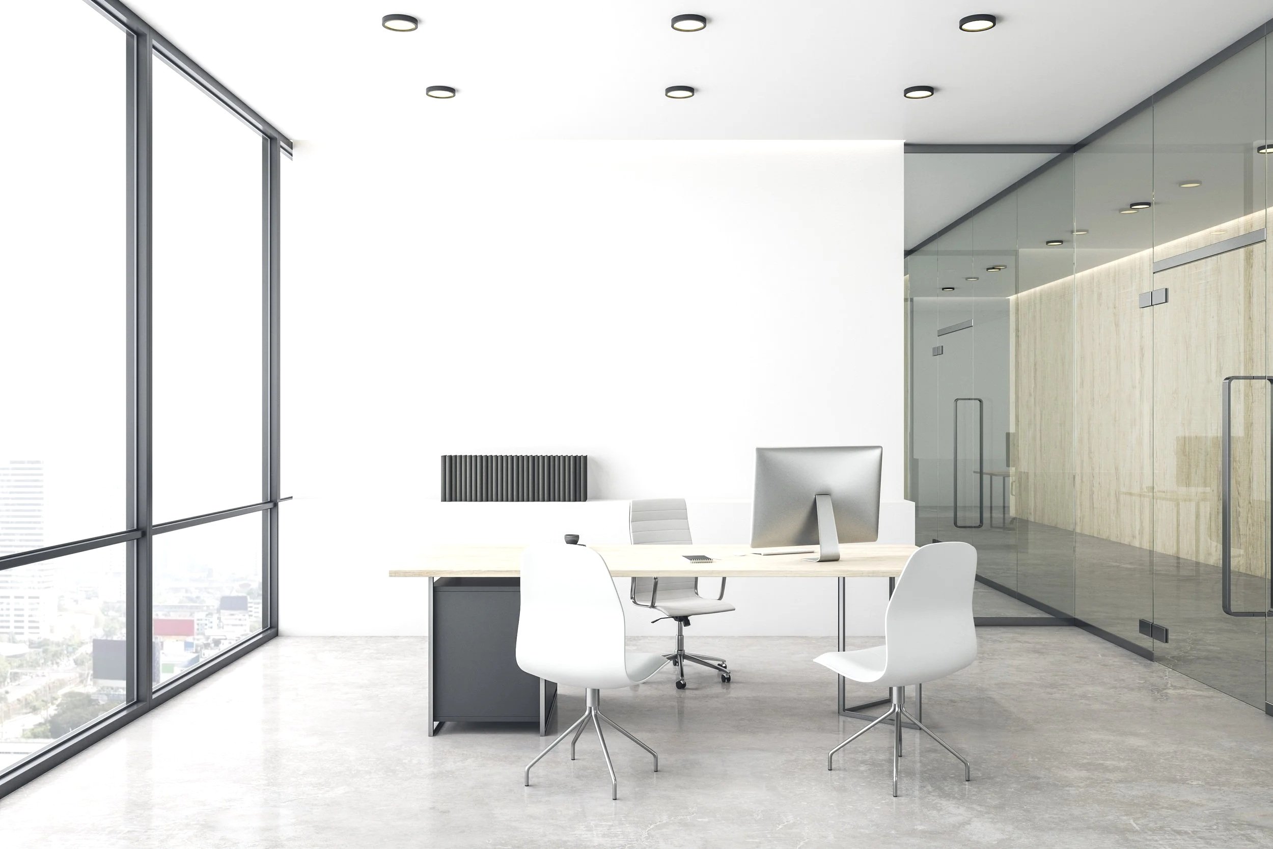Empty modern office with a desk, a computer, white chairs, large windows, and glass walls.